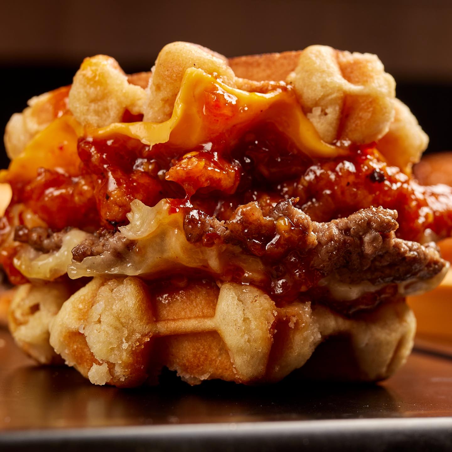 The waffle burger: glazed fried chicken and a smashed patty between two waffles